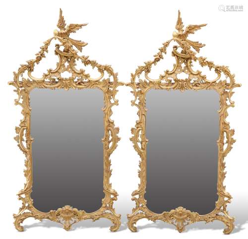 A PAIR OF ROCOCO-STYLE GILTWOOD MIRRORS, each foliate and sc...