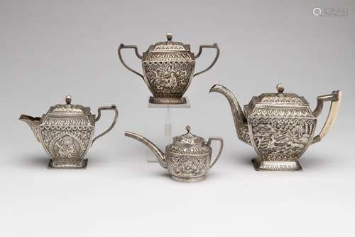 A three-piece silver tea service and a small jug with cover,...