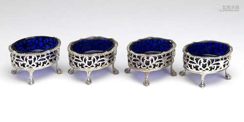 Four English silver salt cellars with blue glass liner