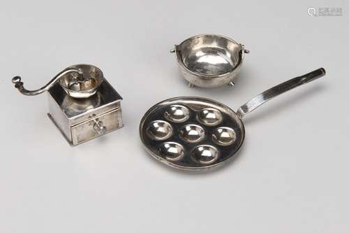 A Dutch silver miniature coffee grinder, a cooking pot and a...