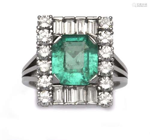 An 18k white gold emerald and diamond dress ring