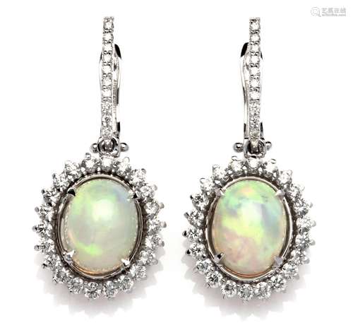 A pair of 18k white gold opal and diamond pendent earrings