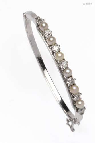 A 14k gold and silver diamond and pearl bangle