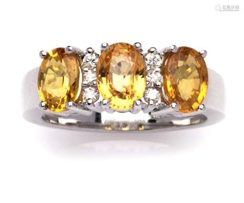 An 18k white gold yellow sapphire and diamond ring