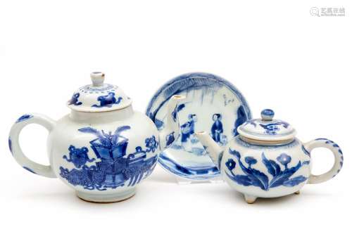 Two blue and white teapots and a saucer