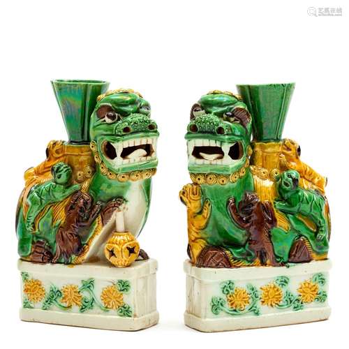 A pair of sancai biscuit porcelain foo dogs