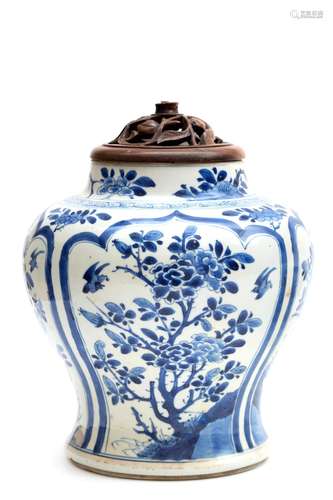 A blue and white vase with wooden lid