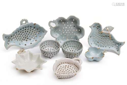 A collection of white Delft strainers