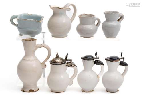 A collection of white Delft miniature jugs