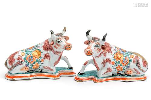 A pair of doré painted Delft pottery reclining cow figures