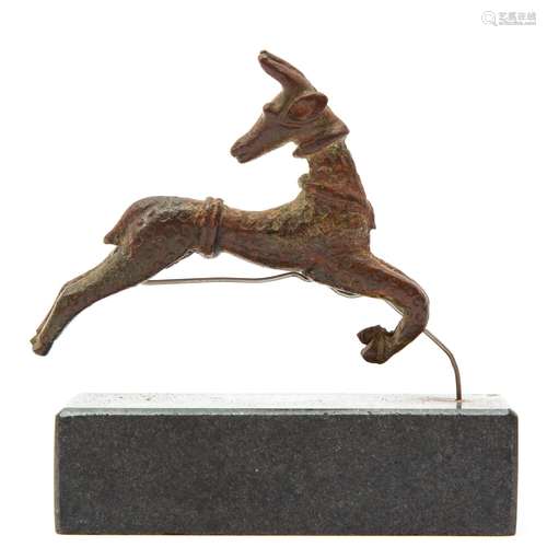 A patinated bronze figure of a leaping deer