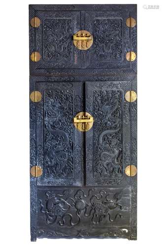 A large Chinese brass-mounted profusely carved four-door com...