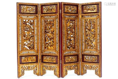 A Chinese carved red-painted and parcel-gilt four-door foldi...