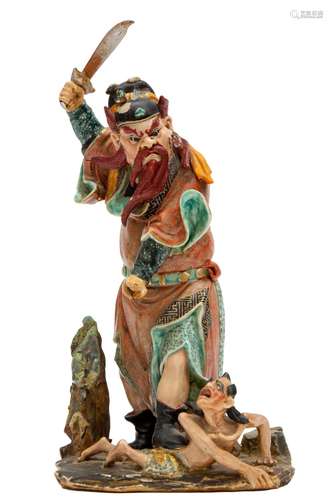 A porcelain figure of Zhong Kui slaying a demon