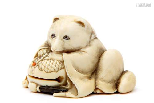 An ivory carved tanuki netsuke