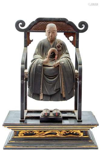 A figure of Kūkai seated on a high chair