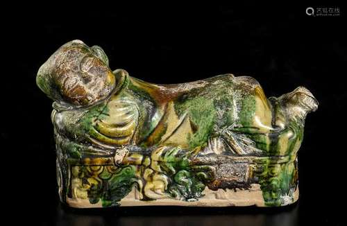 A SANCAI GLAZED CERAMIC 'BOY' PILLOW China, Tang-L...