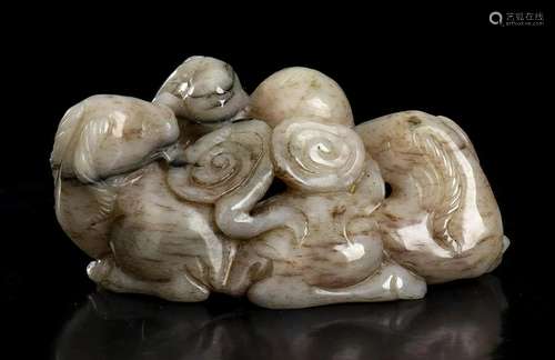 A CREAM AND DARK BROWN JADE GROUP WITH THREE RAMS AND