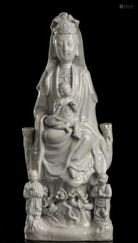 A 'BLANC DE CHINE' PORCELAIN GUANYIN ON THRONE WIT...