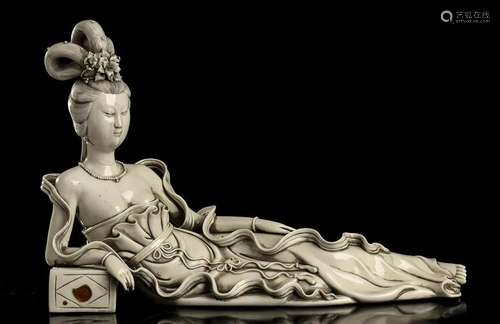 A 'BLANC DE CHINE' PORCELAIN RECUMBENT GUANYIN Chi...