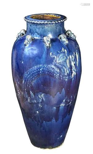 A LARGE BLUE GLAZED MARTABAN CERAMIC 'DRAGON' JAR