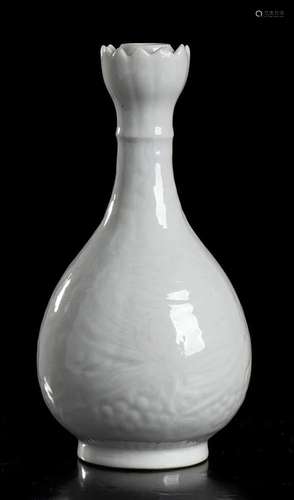 A WHITE GLAZED AND MOULDED DECORATED PORCELAIN BOTTLE