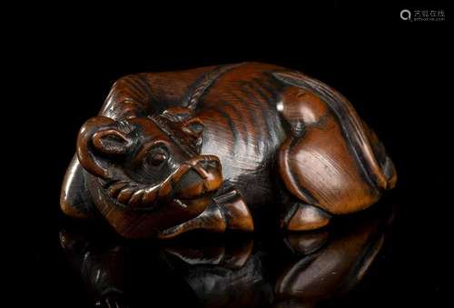 A BOXWOOD NETSUKE WITH A RECUMBENT OX Japan, Edo