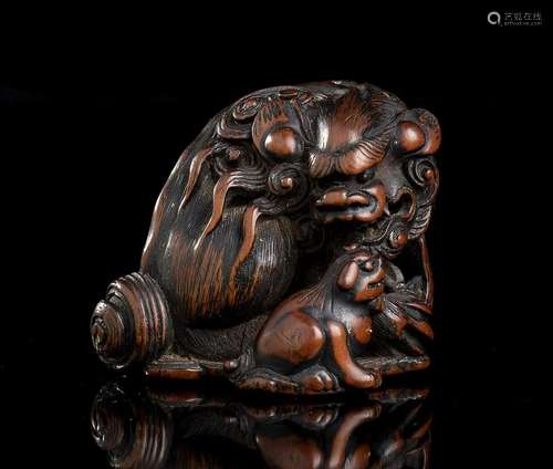 A BOXWOOD NETSUKE WITH A SHISHI Japan, Edo period,