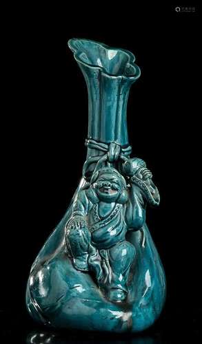 A TURQUOISE GLAZED PORCELAIN BOTTLE VASE WITH DAIKOKU