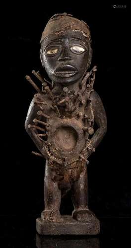 A WOOD, NAILS, FIBER AND GLASS FETISH FIGURE Africa