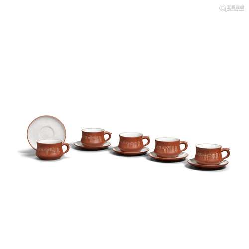 A SET OF FIVE YIXING STONEWARE CUPS AND SAUCERS