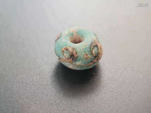 A SPRING AND AUTUMN PERIOD INK PATTERN GLASS BEAD