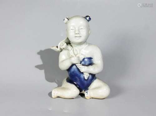 BLUE AND WHITE KID PORCELAIN FIGURINE