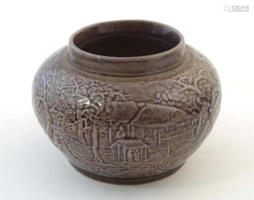 A small Chinese pot of squat form with cast landsc…