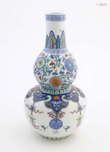 A Chinese double gourd vase with doucai style deco…