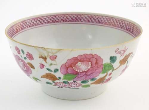 A Chinese bowl decorated with flowers and foliage,…