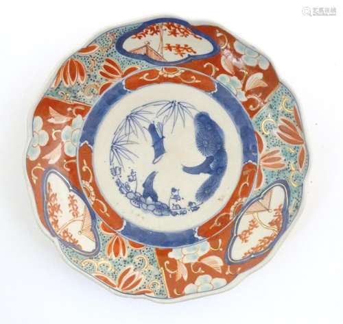 A Japanese plate decorated in the Imari palette wi…