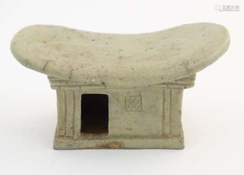 An Oriental stoneware neck pillow / headrest with …
