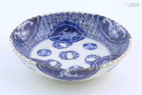 An Oriental blue and white dish with fluted rim, d…