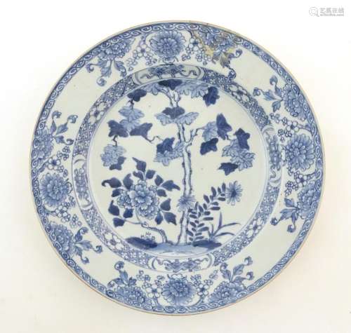 A Chinese blue and white plate decorated with flow…