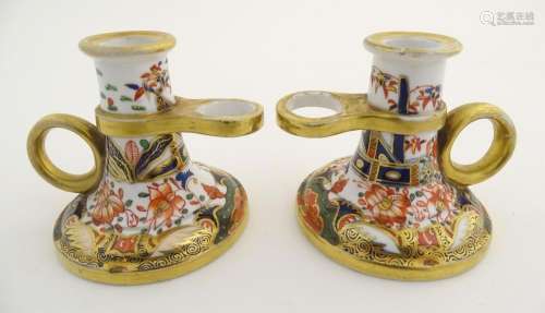 A pair of Derby style chamber sticks in the Imari …
