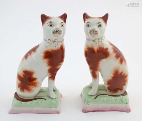 A pair of Victorian Staffordshire pottery cats wit…