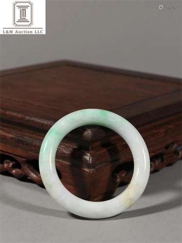 A Chinese Carved Jadeite Bracelet