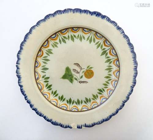A pearlware plate with foliage and fruit to centre…