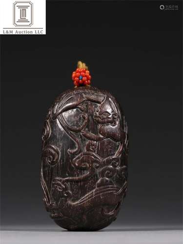 A Chinese Carved Zitan Wood Pendant with Dragon Pattern