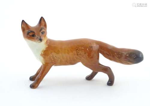 A Beswick model of a standing fox, model no. 1440.…