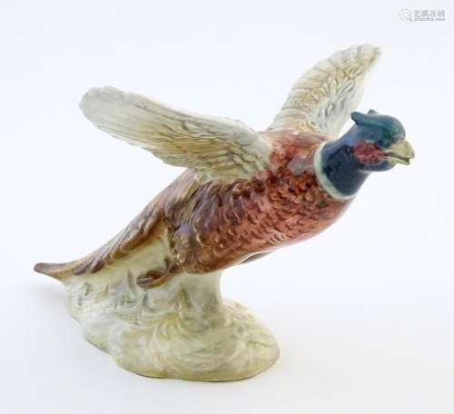 A Beswick model of a pheasant / game bird in fligh…