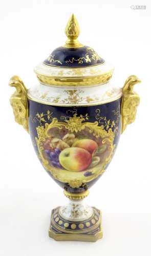 A Coalport twin handled lidded pedestal vase with …