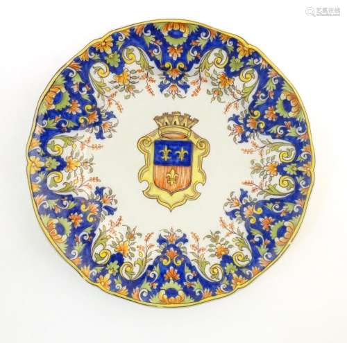 A Continental faience style plate with armorial cr…