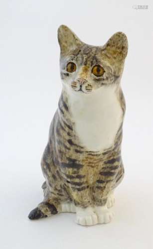 A large Winstanley model of a seated cat. Marked u…